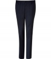 Elegant trousers in fine, wool stretch blend - Classically cool in navy with chic pin stripe - Modern, slim cut is more fitted through legs - Crease detail flatters and elongates the silhouette - Medium rise, button closure and belt loops - Welt pockets at rear - Polished and sleek, an easy go-to in any wardrobe - Dress up with a blazer and button down, or go for a more casual look with a cashmere pullover or light cardigan