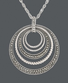 For stellar style and a hint of sparkle -- simply add a little Genevieve & Grace! This chic, orbital pendant features graduated circles that cause a stir with rope edging and glittering marcasite accents. Crafted in sterling silver. Approximate length: 18 inches. Approximate drop: 2-1/8 inches. For stellar style and a hint of sparkle -- simply add a little Genevieve & Grace! This chic, orbital pendant features graduated circles that cause a stir with rope edging and glittering marcasite accents. Crafted in sterling silver. Approximate length: 18 inches. Approximate drop: 2-1/8 inches.