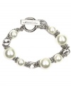 Wrap your wrists in something luxurious. Givenchy's sophisticated flex bracelet features white glass pearls and sparkling crystals set in silver tone mixed metal. Bracelet features a toggle closure. Approximate length: 7-1/2 inches.