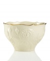 With lush roses and delicate dots carved in ivory porcelain, this classic bowl is a fine caddy for sweet treats. A scalloped, gold-tipped rim adds an element of grandeur to any tabletop. Qualifies for Rebate