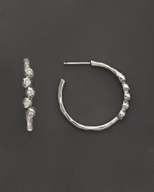 Faceted diamonds gleam in sterling silver hoops. By Ippolita.