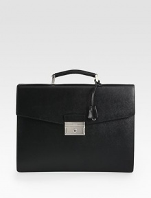 Signature, structured briefcase style of textured saffiano leather.Top handle, 1½ dropFlap, push lock closureInterior open, zip pocketsLeather15W x 11H x 2DMade in Italy Signature, structured briefcase style of textured saffiano leather.Top handle, 1½ dropFlap, push lock closureInterior open, zip pocketsLeather15W x 11H x 2DMade in Italy
