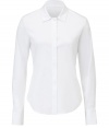 Theory updates the classic button-up blouse with this flattering, slim-fitting iteration - Spread collar, concealed button front placket, long sleeves, curved hem, slim fit - Pair with cropped trousers, a cashmere cardigan, and classic pumps