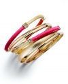 Covet the colorblock. INC International Concepts' trendy 5 bangle set combines smooth and sandblasted 12k gold-plated bangles with wrapped fuchsia-colored nylon thread. Approximate diameter: 2-1/2 inches.