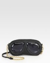 A unique, shapely design of leather and PVC mimics your favorite pair of shades.Removable adjustable chain and leather shoulder strap, 19-22 dropTop zip closureFully lined9½W X 5H X 1DImported