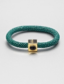 An exotic and luxurious design that features a stingray leather covered bangle accented with a colorful stone set in a logo accented closure. Available in grey stingyray with coral stone, green stingray with onyx stone, or blue stingray with jasper stone.Stingray leatherLength, about 7.5Magnetic closureMade in Italy An exotic and luxurious design that features a stingray leather covered bangle accented with a colorful stone set in a logo accented closure. Available in grey stingyray with coral stone, green stingray with onyx stone, or blue stingray with jasper stone.Stingray leatherLength, about 7.5Magnetic closureMade in Italy
