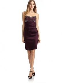 THE LOOKStrapless sweetheart necklinePearl and rhinestone trimAsymmetric tucks down frontSeamed back with invisible zip closureTHE FITAbout 20½ from natural waist to hemTHE MATERIAL64% acetate/33% nylon/3% spandexFully linedCARE & ORIGINDry cleanMade in USAModel shown is 5'9½ (176cm) wearing US size Small. THE LOOKStrapless sweetheart necklinePearl and rhinestone trimAsymmetric tucks down frontSeamed back with invisible zip closureTHE FITAbout 20½ from natural waist to hemTHE MATERIAL64% acetate/33% nylon/3% spandexFully linedCARE & ORIGINDry cleanMade in USAModel shown is 5'9½ (176cm) wearing US size Small.