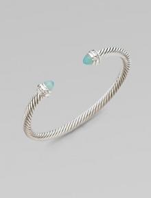 From the Cable Collection. A signature cable design with pretty aqua chalcedony caps accented in sparkling diamonds. Aqua chalcedonyDiamonds, .2 tcwSterling silverDiameter, about 2½Slip-on styleImported 