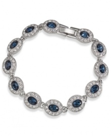 A fashionista's dream. This Carolee bracelet features oval-cut blue glass stones surrounded by smaller clear accents. Linked together in a silver tone imitation rhodium mixed metal setting. Approximate length: 7 inches. A fashionista's dream. This Carolee bracelet features oval-cut blue glass stones surrounded by smaller clear accents. Linked together in a silver tone imitation rhodium mixed metal setting. Approximate length: 7 inches.
