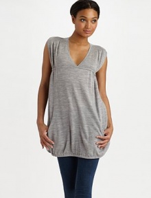 THE LOOKRibbed V-neck Pullover style Sleeveless with over-sized ribbed arm holes Drawstring back empire waist Front zip slash pockets Elastic hemTHE FITAbout 31 ½ from shoulder to hemTHE MATERIALMerino woolCARE & ORIGINDry clean Imported