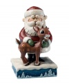 Jim Shore captures a special moment between Santa and his favorite reindeer Rudolph in a collectible figurine that feature a soft palette and details inspired by American folk art.