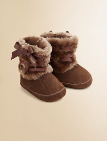 Cozy suede trimmed with soft faux fur and finished with a pretty satin ribbon.Slip-onPolyurethane faux fur trimSuede upperCotton liningSuede soleImported Cozy suede trimmed with soft faux fur and finished with a pretty satin ribbon.Slip-onPolyurethane faux fur trimSuede upperCotton liningSuede soleImported