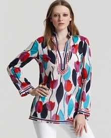 Bold florals bloom across a breezy Tory Burch tunic for a refined take on bohemian-chic. Showcase the vivid hues against white denim.