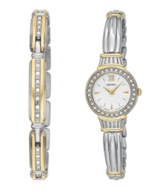 This beautiful Seiko watch is crafted with an elegant, antiquated look. Silvertone and goldtone bracelet and round case. Bezel crystallized by Swarovski elements. White dial with logo, goldtone stick indices and Roman numeral at twelve o'clock. Analog quartz movement. Water resistant to 30 meters. Two-year limited warranty. Matching bracelet crafted in sterling silver. Approximate length: 7-1/2 inches.