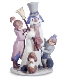 Lladro captures the magical moment as a boy and girl bring to life a snowman they just made, while their dog looks on in amazement. Handcrafted in Spain.