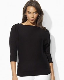 Channel modern elegance in the Jezzy sweater, rendered in a luxuriously soft blend of silk and cashmere with dramatic dolman sleeves and chic buttons at the neckline. Channel modern elegance in the Jezzy sweater, rendered in a luxuriously soft blend of silk and cashmere with dramatic dolman sleeves and chic buttons at the neckline.