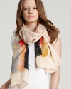 A luxurious silk scarf with an abstract watercolor-like print.