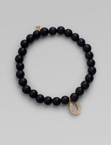 A good luck charm, depicted in diamonds set in 14k yellow gold, hangs from a simple strand of black onyx beads. Diamonds, 0.08 tcw Black onyx 14k yellow gold Diameter, about 2 Charm length, about ½ Stretch cord Imported