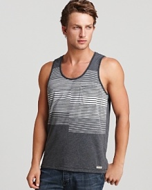 A unique, optically intriguing print of varying stripes is color-blocked on a soft cotton tank for a chilled-out, on-trend warm weather look. A unique, optically intriguing print of varying stripes is color-blocked on a soft cotton tank for a chilled-out, on-trend warm weather look.