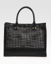 Chic logo cut-outs lend a signature touch to this roomy leather carryall.Double top handles, 7 dropTop snap closureProtective metal feet17W X 13½H X 4½DImported