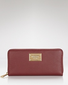 This effortless wallet captures the cosmopolitan essence of MICHAEL Michael Kors with its slim profile and sophisticated leather. This effortless wallet captures the cosmopolitan essence of MICHAEL Michael Kors with its slim profile and sophisticated leather.
