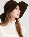 A fabulous wool felt floppy hat with a feather accent brings boho style to your favorite ensemble.