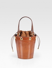 Rimmed in bold grommets, this stunning bucket-shaped bag of rich saddle leather has a drawstring top of velvety suede.Double top handles, 5½ drop Drawstring top closure Suede lining 4½W X 7H X 18D Made in Italy Rimmed in bold grommets, this stunning bucket-shaped bag of rich saddle leather has a drawstring top of velvety suede.Double top handles, 5½ drop Drawstring top closure Suede lining 4½W X 7H X 18D Made in Italy