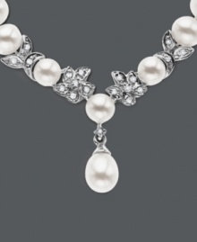 Cultured freshwater pearls (5.5-6mm) are paired with 14k white gold floral accents and shimmering diamond accents. Length measures 18 inches. Cultured freshwater pearls (5.5-6mm) are paired with 14k white gold floral accents and shimmering diamond accents. Length measures 18 inches.