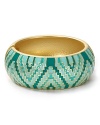 Aqua puts an on-trend spin on this season's global influences with this enamel bangle. This piece's bold zig-zag print perfects an eclectic look an armful of similar styles.