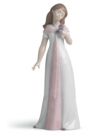 Forever elegant. This handmade porcelain figurine presents a young woman in fresh white and pink with carved floral detailing, sure to make a lasting, graceful statement in any home. Forever elegant. This handmade porcelain figurine presents a young woman in fresh white and pink with carved floral detailing, sure to make a lasting, graceful statement in any home.