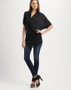 Wrap-front jersey top drapes to one hip, dipping lower at front hem.V-neck pullover Side draping Short dolman sleeves Asymmetrical hem About 31 long Micro modal; dry clean Imported