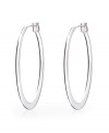 Polish your look in sleek, modern style. Monet earrings feature a sophisticated oval hoop set in silver tone mixed metal. Approximate diameter: 2 inches.