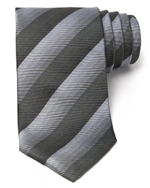 Thin tonal stripes dash across this handsome tie, rendered in luxurious Italian silk for classic opulence. Thin tonal stripes dash across this handsome tie, rendered in luxurious Italian silk for classic opulence.
