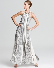 A geometric print lends modernity to the flowing silhouette of this BCBGMAXMAZRIA gown, designed with a halter neckline, draped front panel and exposed scoop back. Dramatic and daring, this piece was made for appearances.