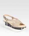 Two-tone, mixed-media platform wedge design accented by supple leather criss-cross straps. Rubber and wooden wedge, 2 (50mm)Rubber and wooden platform, 1½ (40mm)Compares to a ½ heel (15mm)Leather upperLeather liningRubber soleMade in Italy