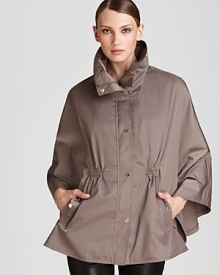 Complete your rainy day look with Calvin Klein's captivating cape, boasting a funnel collar with practical zip-out hood and flattering cinched waist.