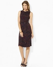 Crafted in sleek rayon jersey, a chic sleeveless dress is finished in a sweeping paisley pattern with a draped neckline.