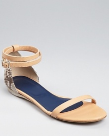 Blending neutral-hued leather and snake embossed details, this fashion-forward sandal from Tibi is easily dressed up or down.