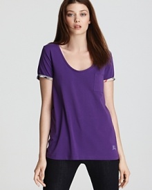 A vibrant jewel tone elevates your classic Burberry Brit tee shirt, while check lining lends an unexpected pop of pattern to the wardrobe essential. A vibrant jewel tone elevates your classic Burberry Brit tee shirt, while check lining lends an unexpected pop of pattern to the wardrobe essential.