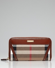 Sleek and city cool. This zip around wallet from Burberry is an style set essential, with ample pockets for on-the-go allure. Sleek and city cool. This zip around wallet from Burberry is an style set essential, with ample pockets for on-the-go allure.