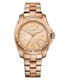 Classically styled timepiece with popping rosy hues, by Tommy Hilfiger. Crafted of rose-gold tone stainless steel bracelet and round case. Rose-gold tone dial features Arabic numerals at three, six, nine and twelve o'clock, stick indices, three hands and logo at twelve o'clock. Quartz movement. Water resistant to 30 meters. Ten-year limited warranty. Classically styled timepiece with popping rosy hues, by Tommy Hilfiger. Crafted of rose-gold tone stainless steel bracelet and round case. Rose-gold tone dial features Arabic numerals at three, six, nine and twelve o'clock, stick indices, three hands and logo at twelve o'clock. Quartz movement. Water resistant to 30 meters. Ten-year limited warranty.