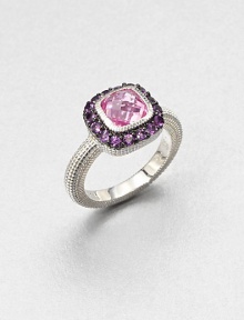 A cushion-cut pink corundum stone surrounded by pavé amethyst stones with a textured sterling silver shank. Pink corundum and amethystSterling silverWidth, about .5Imported 