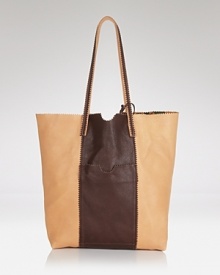 Endlessly versatile, this Carlos Falchi tote is a step beyond the tried-and-true, crafted from rich leather. It's the bag to throw over your shoulder day in and out. Endlessly versatile, this Carlos Falchi tote is a step beyond the tried-and-true, crafted from rich leather. It's the bag to throw over your shoulder day in and out.