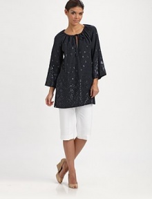 An enticing tunic with spectacular beading, a flattering fit and convenient slash pockets. Round neckSelf-tieThree-quarter sleevesSlash pocketsPull-on styleAbout 32 from shoulder to hemLinenDry cleanImported