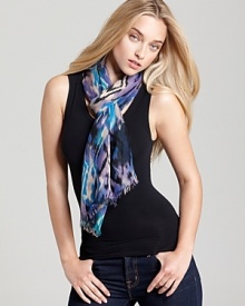 A bohemian oblong scarf with colorful ikat print and self fringe edges.