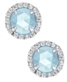 A mesmerizing accent piece, from CRISLU. These stud earrings feature a dome-cut center stone aquamarine (1-1/5 ct. t.w.) surrounded by micro-pave cubic zirconia accents. Earrings set in platinum over sterling silver. Approximate diameter: 1/3 inch.