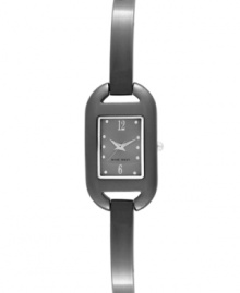 Delicate details add an air of elegance to this Nine West watch. Crafted of gunmetal tone mixed metal strap and rectangular case. Gray dial features silver tone dot markers, numerals at six and twelve o'clock, silver tone hour and minute hands, sweeping second hand and logo at six o'clock. Quartz movement. Limited lifetime warranty.