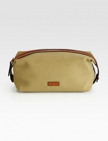 An impeccably stylish carrying case for the modern gentleman, this lightweight pouch in a leather-trimmed canvas construction provides sharp transport for essential toiletries.Zip closureInterior zip pocketAntiqued brass hardwareEmbossed leather logo accents the exteriorCanvas9W x 5HImported An impeccably stylish carrying case for the modern gentleman, this lightweight pouch in a leather-trimmed canvas construction provides sharp transport for essential toiletries.Zip closureInterior zip pocketAntiqued brass hardwareEmbossed leather logo accents the exteriorCanvas9W x 5HImported