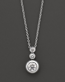 White gold bezel-set diamond necklace in three-stone drop design. With signature ruby accent. Designed by Roberto Coin.