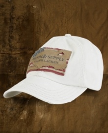 A faded baseball hat gets the signature treatment with a patched signature flag and a well-worn frayed appearance.